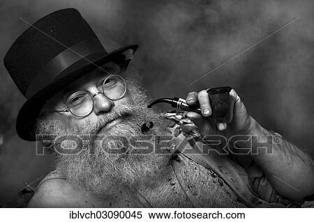 "Elderly man with a long beard wearing a top hat and glasses, smoking a pipe, Reith im Alpbachtal, Kufstein District, North Tirol, Tirol, Austria, Europe" View Large Photo Image Stock Photography - "Elderly man with a long beard wearing a top hat and glasses, smoking a pipe, Reith im Alpbachtal, Kufstein District, North Tirol, Tirol, Austria, Europe". Fotosearch