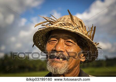 "Elderly rice farmer wearing a straw hat, Ubud district, Bali, Indonesia, Asia" View Large Photo Image Stock Image - "Elderly rice farmer wearing a straw hat, Ubud district, Bali, Indonesia, Asia". Fotosearch