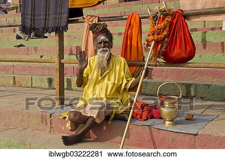 "Elderly Sadhu, holy man or wandering ascetic sitting on a blanket on the steps on the bank of the Ganges River with various ritual objects beside him, Varanasi, Uttar Pradesh, India, Asia" View Large Photo Image Stock Image - "Elderly Sadhu, holy man or wandering ascetic sitting on a blanket on the steps on the bank of the Ganges River with various ritual objects beside him, Varanasi, Uttar Pradesh, India, Asia". Fotosearch