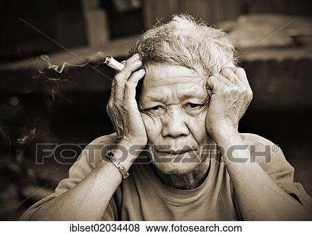 "Elderly, thoughtful man with a cigar holding his head in his hands, Laos, Southeast Asia, Asia" View Large Photo Image Stock Photo - "Elderly, thoughtful man with a cigar holding his head in his hands, Laos, Southeast Asia, Asia". Fotosearch