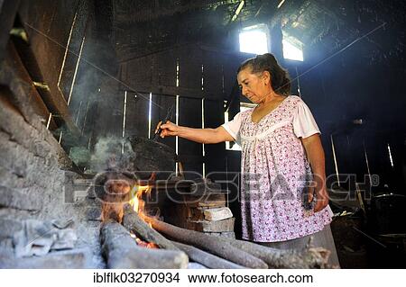 "Elderly woman in a basic kitchen cooking on an open fire, Carayao, Caaguazu Department, Paraguay, South America" View Large Photo Image Picture - "Elderly woman in a basic kitchen cooking on an open fire, Carayao, Caaguazu Department, Paraguay, South America". Fotosearch
