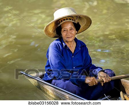 "Elderly woman on a boat, floating market, Damnoen Saduak, Thailand, Asia" View Large Photo Image Stock Photo - "Elderly woman on a boat, floating market, Damnoen Saduak, Thailand, Asia". Fotosearch