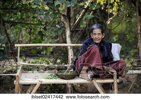 Elderly woman sitting on a bench made of bamboo, Myanmar, Burma, Southeast Asia, Asia View Large Photo Image Stock Image - Elderly woman sitting on a bench made of bamboo, Myanmar, Burma, Southeast Asia, Asia. Fotosearch