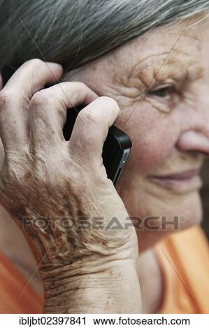 Stock Image - Elderly woman using a smartphone. Fotosearch