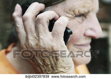 Elderly woman using a smartphone View Large Photo Image Stock Photo - Elderly woman using a smartphone. Fotosearch