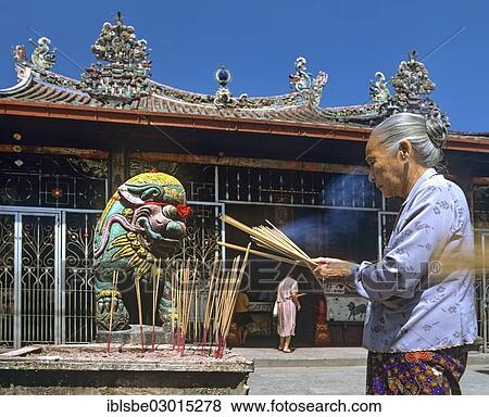 "Elderly woman with incense, offerings, Kuan Yin, Chinese temple, Georgetown, Penang, Malaysia, Asia" View Large Photo Image Stock Photo - "Elderly woman with incense, offerings, Kuan Yin, Chinese temple, Georgetown, Penang, Malaysia, Asia". Fotosearch