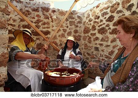 "Elderly women in traditional costume baking """"bunyols"""", typical fried dough balls, at a traditional handicraft fair, Ibiza, Spain, Europe" View Large Photo Image Stock Photo - "Elderly women in traditional costume baking """"bunyols"""", typical fried dough balls, at a traditional handicraft fair, Ibiza, Spain, Europe". Fotosearch