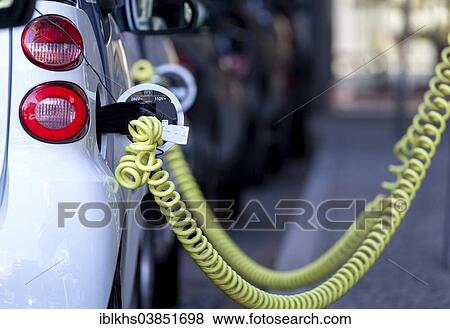 "Electric car being charged at a public charging station, Berlin, Germany, Europe" View Large Photo Image Stock Photo - "Electric car being charged at a public charging station, Berlin, Germany, Europe". Fotosearch