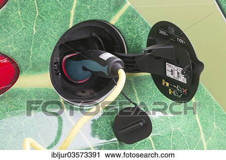 Stock Image - "Electric car being charged in a charging socket at the front of the Telekom-Zentrale headquarters, Bonn, North Rhine-Westphalia, Germany, Europe". Fotosearch
