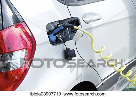 Stock Image - "Electric car recharging at a charging station, Hesse, Germany, Europe". Fotosearch