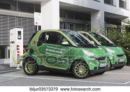 Stock Photo - "Electric cars being charged in a charging socket at the front of the Telekom-Zentrale headquarters, Bonn, North Rhine-Westphalia, Germany, Europe". Fotosearch