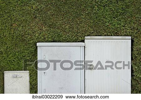 "Electrical boxes and Telekom switch boxes in front of a freshly-cut hedge (Thuja), Freising, Upper Bavaria, Bavaria, Germany, Europe" View Large Photo Image Stock Photo - "Electrical boxes and Telekom switch boxes in front of a freshly-cut hedge (Thuja), Freising, Upper Bavaria, Bavaria, Germany, Europe". Fotosearch