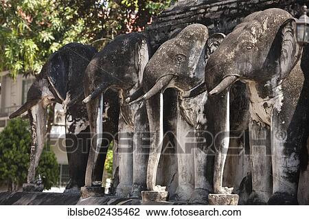 Stock Image - "Elephant statues at the base of the Chedi, Wat Chiang Man, Chiang Mai, Northern Thailand, Thailand, Asia". Fotosearch