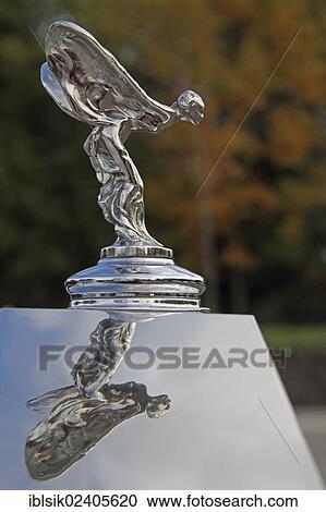 Stock Image - "Emil, hood ornament on a Rolls Royce, with a reflection, classic car". Fotosearch