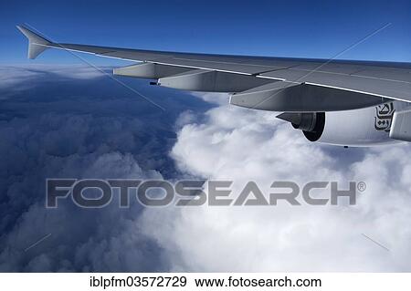 Emirates Airbus A-380 aircraft wing flying above clouds View Large Photo Image Stock Photo - Emirates Airbus A-380 aircraft wing flying above clouds. Fotosearch