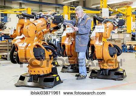 "Employee of the robot manufacturer KUKA AG completing the shipping documents before delivery of KUKA robots, Augsburg, Bavaria, Germany, Europe" View Large Photo Image Stock Image - "Employee of the robot manufacturer KUKA AG completing the shipping documents before delivery of KUKA robots, Augsburg, Bavaria, Germany, Europe". Fotosearch