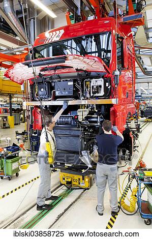 "Employees assembling the chassis, engine and gearbox to the cab, at MAN Truck and Bus AG, Munich, Upper Bavaria, Bavaria, Germany, Europe" View Large Photo Image Stock Photography - "Employees assembling the chassis, engine and gearbox to the cab, at MAN Truck and Bus AG, Munich, Upper Bavaria, Bavaria, Germany, Europe". Fotosearch