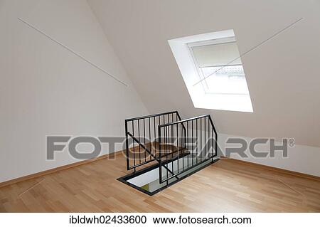 Stock Image - Empty room in the top floor with a staircase railing. Fotosearch