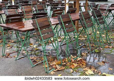 "Empty tables and chairs of an outdoor restaurant in the rain with autumn leaves in the historic city centre of Cologne, Rhineland, North Rhine-Westphalia, Germany, Europe, PublicGround, Europe" View Large Photo Image Stock Image - "Empty tables and chairs of an outdoor restaurant in the rain with autumn leaves in the historic city centre of Cologne, Rhineland, North Rhine-Westphalia, Germany, Europe, PublicGround, Europe". Fotosearch