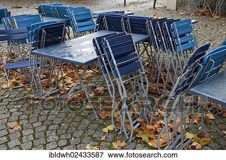 "Empty tables and chairs of an outdoor dining in the rain with autumn leaves in the historic city centre of Cologne, Rhineland, North Rhine-Westphalia, Germany, Europe, PublicGround, Europe" View Large Photo Image Stock Photo - "Empty tables and chairs of an outdoor dining in the rain with autumn leaves in the historic city centre of Cologne, Rhineland, North Rhine-Westphalia, Germany, Europe, PublicGround, Europe". Fotosearch