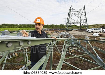 "Engineer checking screw connections on segments of extra high-voltage pylons of a 380 kV extra-high voltage power line under construction, Wipfratal, Thuringia, Germany, Europe" View Large Photo Image Stock Photo - "Engineer checking screw connections on segments of extra high-voltage pylons of a 380 kV extra-high voltage power line under construction, Wipfratal, Thuringia, Germany, Europe". Fotosearch