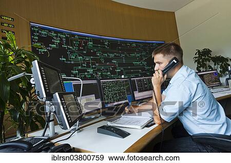 "Engineer sitting at his work station in the Transmission Control Center, TCC, of transmission network operator 50Hertz, Neuenhagen, Brandenburg, Germany, Europe" View Large Photo Image Stock Photo - "Engineer sitting at his work station in the Transmission Control Center, TCC, of transmission network operator 50Hertz, Neuenhagen, Brandenburg, Germany, Europe". Fotosearch