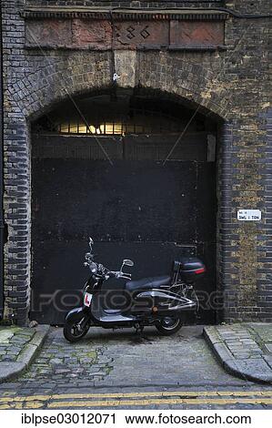 "Entrance to an old warehouse in Blossom Street with a motor scooter parked in front, City of London, London, London region, England, United Kingdom, Europe" View Large Photo Image Stock Image - "Entrance to an old warehouse in Blossom Street with a motor scooter parked in front, City of London, London, London region, England, United Kingdom, Europe". Fotosearch