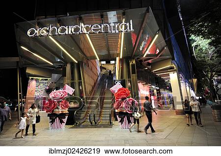 Stock Photo - "Entrance with escalators, Orchard Central shopping centre, Orchard Road at night, modern architecture, Central Area, Central Business District, Singapore, Asia". Fotosearch