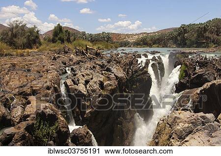 Stock Image - "Epupa Falls, waterfall, formed by the Kunene River directly on the border with Angola, about 40 m, Epupa, Kaokoland, Kunene, Namibia, Africa". Fotosearch