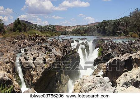 Stock Photograph - "Epupa Falls, waterfall, formed by the Kunene River directly on the border with Angola, about 40 m, Epupa, Kaokoland, Kunene, Namibia, Africa". Fotosearch