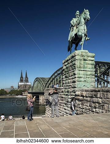 "Equestrian statue of Kaiser Wilhelm I of Prussia, Deutz, Hohenzollernbruecke bridge and Cologne Cathedral at the back, tourists taking pictures, North Rhine-Westphalia, Germany, Europe, PublicGround, Europe" View Large Photo Image Stock Image - "Equestrian statue of Kaiser Wilhelm I of Prussia, Deutz, Hohenzollernbruecke bridge and Cologne Cathedral at the back, tourists taking pictures, North Rhine-Westphalia, Germany, Europe, PublicGround, Europe". Fotosearch