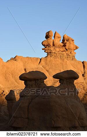 Stock Image - "Eroded hoodoos and Entrada Sandstone rock formations, light and shade, Goblins, Goblin Valley State Park, San Rafael Reef Desert, Utah, Southwestern USA, USA". Fotosearch