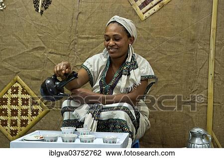 "Ethiopian woman pours coffee in a traditional coffee ceremony, Addis Ababa, Oromia Region, Ethiopia, Africa" View Large Photo Image Stock Image - "Ethiopian woman pours coffee in a traditional coffee ceremony, Addis Ababa, Oromia Region, Ethiopia, Africa". Fotosearch