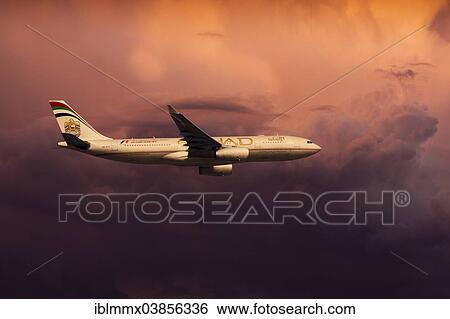 Stock Photograph - "Etihad Airways, Airbus A330-243, in flight, in the evening light". Fotosearch