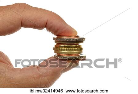 Stock Photograph - Euro coins held between fingers. Fotosearch