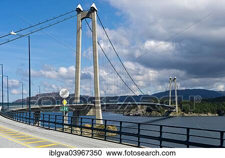 "European Road E39 crossing Stord Bridge or Stordabrua suspension bridge across the sound of Digernessundet, road link between the islands of Stord and Foyno, Stord, Norway, Europe" View Large Photo Image Stock Image - "European Road E39 crossing Stord Bridge or Stordabrua suspension bridge across the sound of Digernessundet, road link between the islands of Stord and Foyno, Stord, Norway, Europe". Fotosearch
