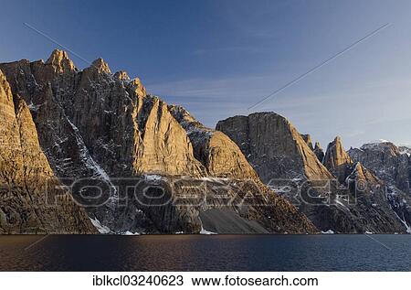 Stock Image - "Evening light on the mountain scenery of Ofjord, Milneland, Scoresbysund, Sermersooq, Greenland, North America". Fotosearch