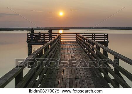 "Evening mood at Jezioro Lebsko or Lebsko Lake, Leba, Pomeranian Voivodeship or Pomorskie Region, Poland, Europe" View Large Photo Image Stock Photography - "Evening mood at Jezioro Lebsko or Lebsko Lake, Leba, Pomeranian Voivodeship or Pomorskie Region, Poland, Europe". Fotosearch