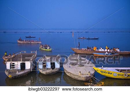 "Evening mood, several boats docked on the bank of the Ganges River, boats with groups of pilgrims passing by on the water, Varanasi, Uttar Pradesh, India, Asia" View Large Photo Image Stock Photo - "Evening mood, several boats docked on the bank of the Ganges River, boats with groups of pilgrims passing by on the water, Varanasi, Uttar Pradesh, India, Asia". Fotosearch