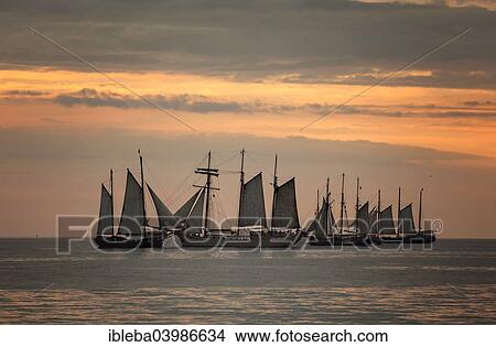 Picture - "Evening sailing with the Mare Frisium in the middle, at the Hanse Sail 2014 Warnemunde, Mecklenburg-Western Pomerania, Germany, Europe". Fotosearch