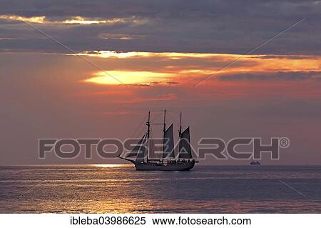 "Evening sailing with three-masted schooner Mare Frisium in the foreground, Hanse Sail 2014 Warnemunde, Mecklenburg-Western Pomerania, Germany, Europe" View Large Photo Image Stock Photography - "Evening sailing with three-masted schooner Mare Frisium in the foreground, Hanse Sail 2014 Warnemunde, Mecklenburg-Western Pomerania, Germany, Europe". Fotosearch