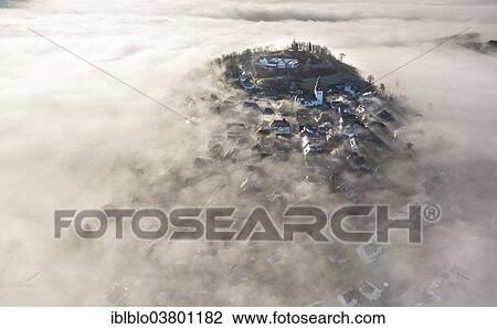 Stock Image - "Eversberg in the fog, Meschede, Sauerland region, North Rhine-Westphalia, Germany, Europe". Fotosearch