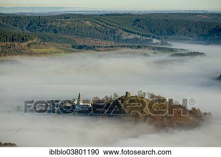 Stock Image - "Eversberg in the fog, Meschede, Sauerland region, North Rhine-Westphalia, Germany, Europe". Fotosearch