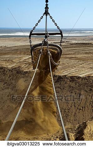 "Excavator bucket of a dragline excavator transporting slag in a diamond mine, De Beers Namaqualand Mines, Kleinzee, South Africa, Africa" View Large Photo Image Stock Photography - "Excavator bucket of a dragline excavator transporting slag in a diamond mine, De Beers Namaqualand Mines, Kleinzee, South Africa, Africa". Fotosearch