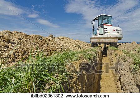 "Excavator digging a ditch through agriculture landscape, Laurich, Saxony, Germany, Europe" View Large Photo Image Stock Image - "Excavator digging a ditch through agriculture landscape, Laurich, Saxony, Germany, Europe". Fotosearch