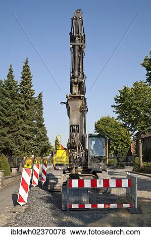 "Excavator for road construction work, renewal of the sewerage system, Koenigstrasse, Kamen, Ruhr Area, North Rhine-Westphalia, Germany, Europe, PublicGround, Europe" View Large Photo Image Stock Photo - "Excavator for road construction work, renewal of the sewerage system, Koenigstrasse, Kamen, Ruhr Area, North Rhine-Westphalia, Germany, Europe, PublicGround, Europe". Fotosearch