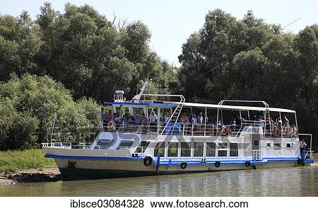 Stock Photo - "Excursion boat in the Danube Delta Biosphere Reserve, Danube Delta Biosphere Reserve, Tulcea, Tulcea County, Romania, Europe". Fotosearch