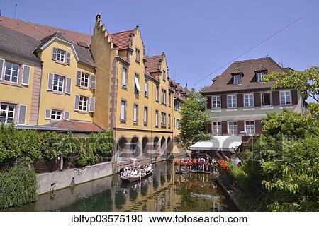 Stock Image - "Excursion boat on a canal, La Petite Venise, Colmar, Departement Haut-Rhin, Alsace, France, Europe". Fotosearch