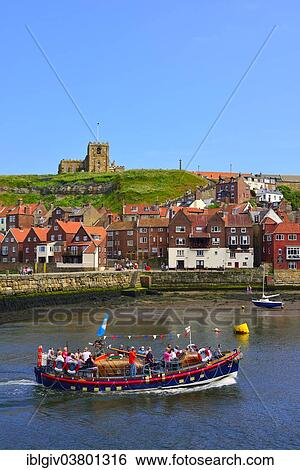 Stock Photograph - "Excursion boat on the River Esk, St. Mary's Church at back, Whitby, North Yorkshire, England, United Kingdom, Europe". Fotosearch