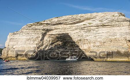 Stock Photo - "Excursion boat visiting a cave in the chalk cliffs, Bonifacio, Corsica, France, Europe". Fotosearch
